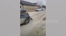 Policeman clings to bonnet of suspect's fleeing car in Russia