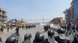 Riot police march on road blocking pro-monarchy protesters demanding a Hindu nation