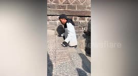 Double amputee climbs sacred mountain steps with just his hands