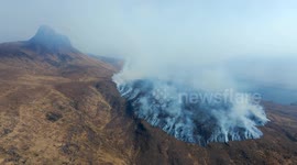 Aerial drone footage of wildfires at Stac Pollaidh mountain near Lochinver in Scottish Highlands