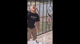 Child struggles to open gate with key in Cali
