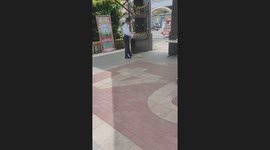 Security guard caring for a cat in Iloilo, Philippines