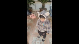 Man uses manual scale to determine boy's weight in Henan, China