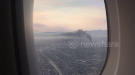 Fire and smoke seen from a plane going over LA