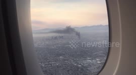 Fire and smoke seen from a plane going over LA