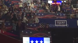 Protestor holds up anti-Trump banner during nomination speech