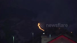 Helicopter night firefighting water drop at