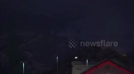 Near dark Helicopter water drop near houses at