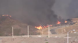 Fireline burning into new development area at