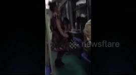 Woman dances to loud music on a train