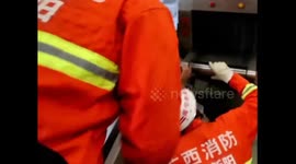 Firefighters rescue a boy stuck his hand in security inspection equipment
