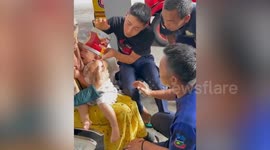 Baby with a biscuit tin stuck on her head is freed by firemen