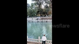 Elderly man effortlessly throw and catch frisbee across 30-metre-wide river in China