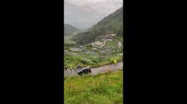 Driver reverses up steep mountain road in Indonesia