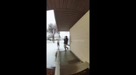 Man falls after slipping on snow in Fargo, North Dakota, USA