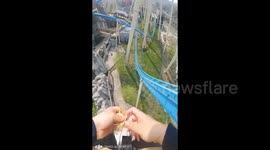 Man casually eats biscuit whilst flying along on high-speed roller coaster