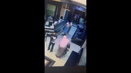 Hotel porter uses office chair as a wheelchair for elderly guest