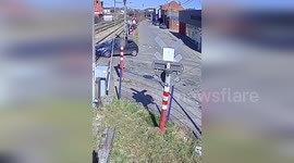 Couple flee as train smashes into car stuck on level crossing