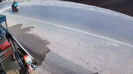 Motorcycle rider cruises through two cars crashing in incredible sliding doors moment