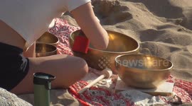 UK Weather, Singing bowls on the sand as the sun sets at Fistral beach, Newquay, Cornwall, UK