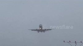 Planes land through snow at Rochester Airport in New York