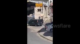 Israeli forces seize a motorcycle owned by a Palestinian during their raid into Anata town