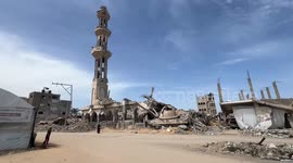 Palestinians in ruins of mosque perform last Friday prayers of Ramadan in Gaza