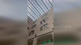 Superheroes carrying gifts abseil in children's hospital in Israel