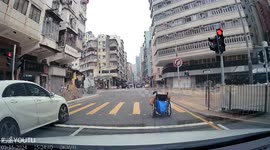 Kind driver helps to push wheelchair user along road