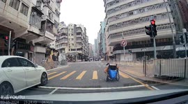 Kind driver helps to push wheelchair user along road