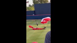 Parachutist Gets Tangled in Net During Pre-Game Stunt at Arizona-OSU Baseball Match
