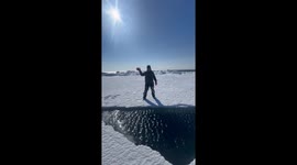 Tourist posing for pictures is terrified when frozen lake cracks