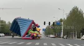 Inflatable playground swept by strong wind at intersection in Henan, China