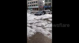 Hailstorm turns streets into rivers of ice in central China
