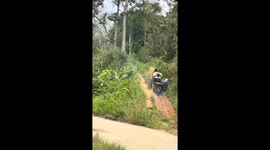 Monkeys help to pull motorcycle up steep hill