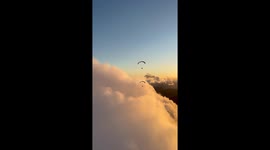 Sunset paramotor flight over the clouds in Rio de Janeiro