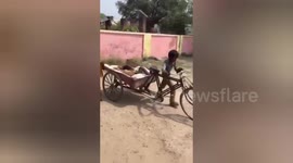 Patient carried on a handcart to third world hospital in India