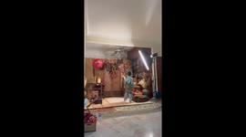 Excited toddler knocks over ornate display for family portrait photo