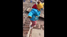 Child falls while jumping stairs then does a trick roll and gets up