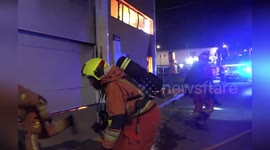 Firefighters break wall to tackle blaze at warehouse in Spain