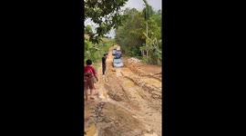 Family tackle deep mud as they drive through rural road