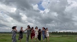 Hilarious moment cow interrupts group of girls posing for video