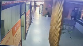 Girl carrying dustpan and brush slips while running down corridor
