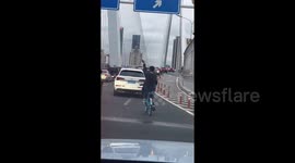 Cyclist's flamboyant hand gestures delight passing motorists
