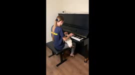 Upside-Down Cat Enjoys Woman's Piano Playing