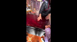 Street magician amazes onlookers with sleight of hand trick with hearts