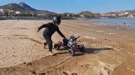 Toddler tears up the sand with cool beach buggy