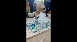 Sensory art in action as child suspended in air paints