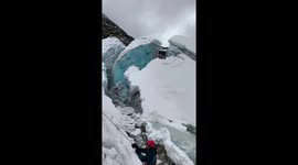 Glacier serac breaks off during ice climbing in Vallunaraju, Peru