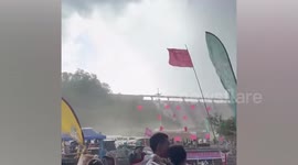 Tourists flee as summer storm lashes dam